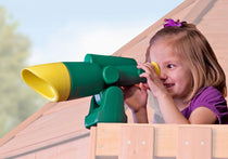 Girl looking through the green and yellow toy telescope on a swing set fort