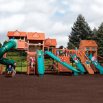Children playing on a large wooden playground with slides and climbing structures.