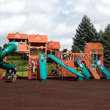 Children playing on a large wooden playground with slides and climbing structures.
