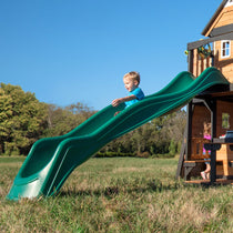 Boy riding the green 3-metre wave slide mounted on a swing set