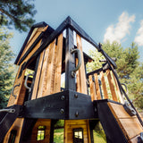 Canyon Creek upper fort seen from below, showing cedar cladding, charcoal framing and grab handles