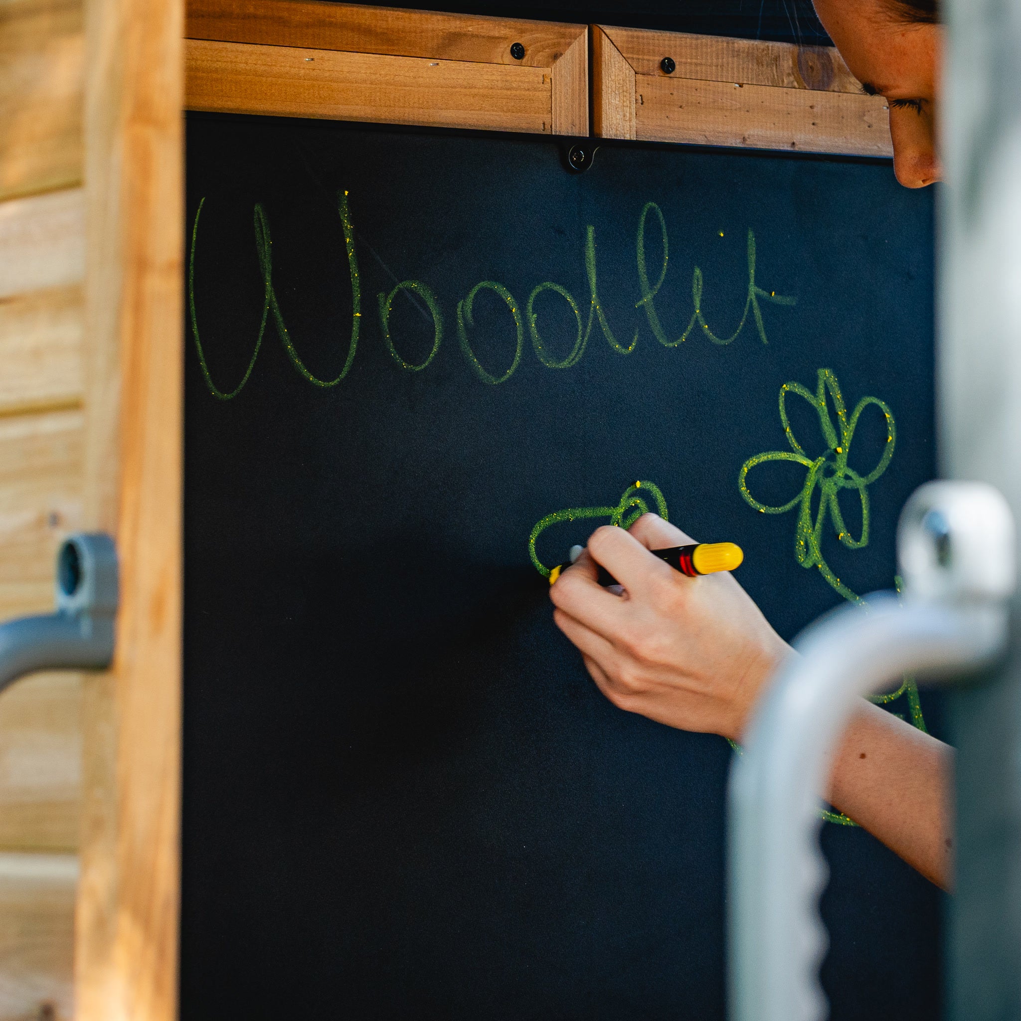 Child drawing in chalk on the Canyon Creek upper fort chalkboard